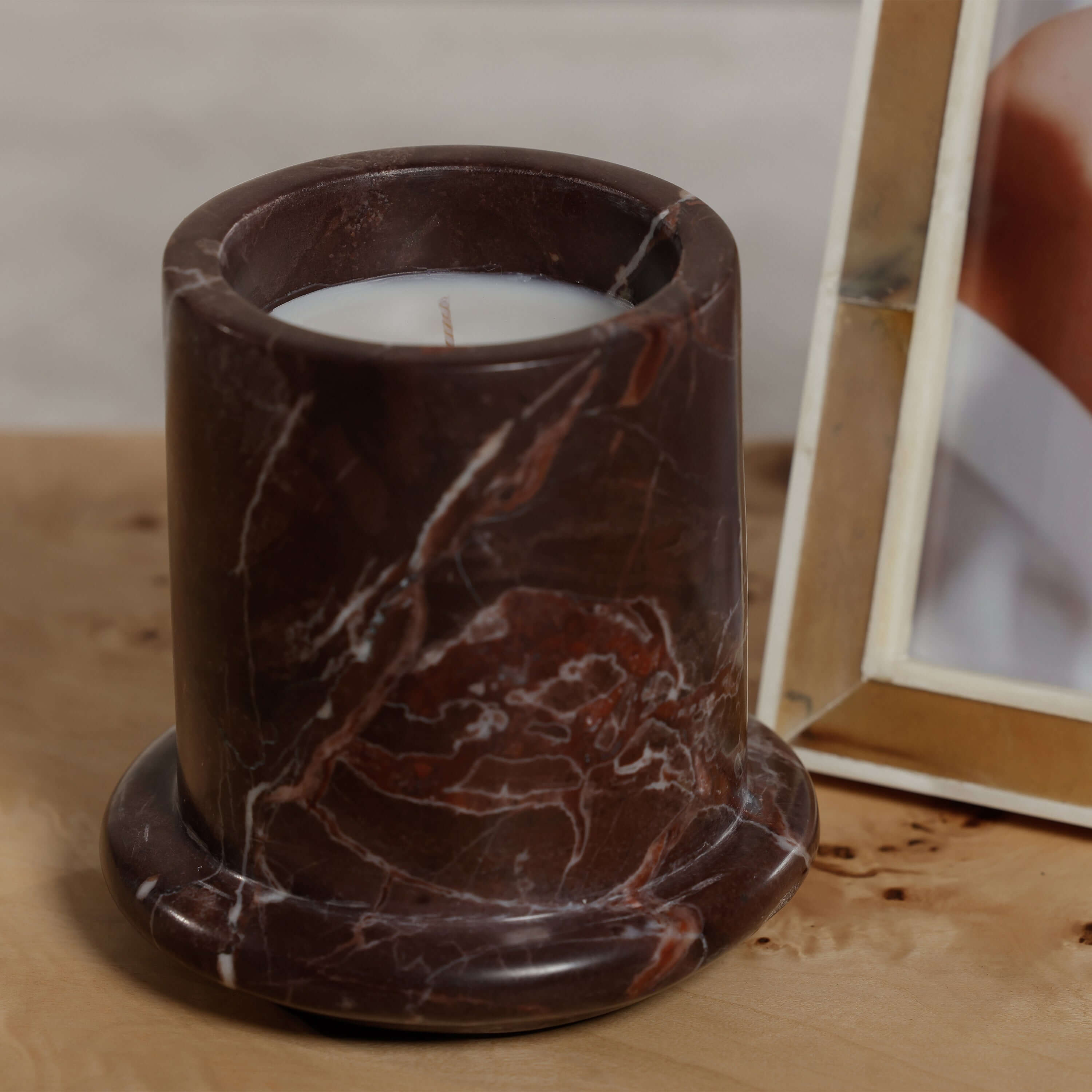 Marbella Scented Candle Jar with Cloche displayed on a wooden surface, showcasing natural marble design.