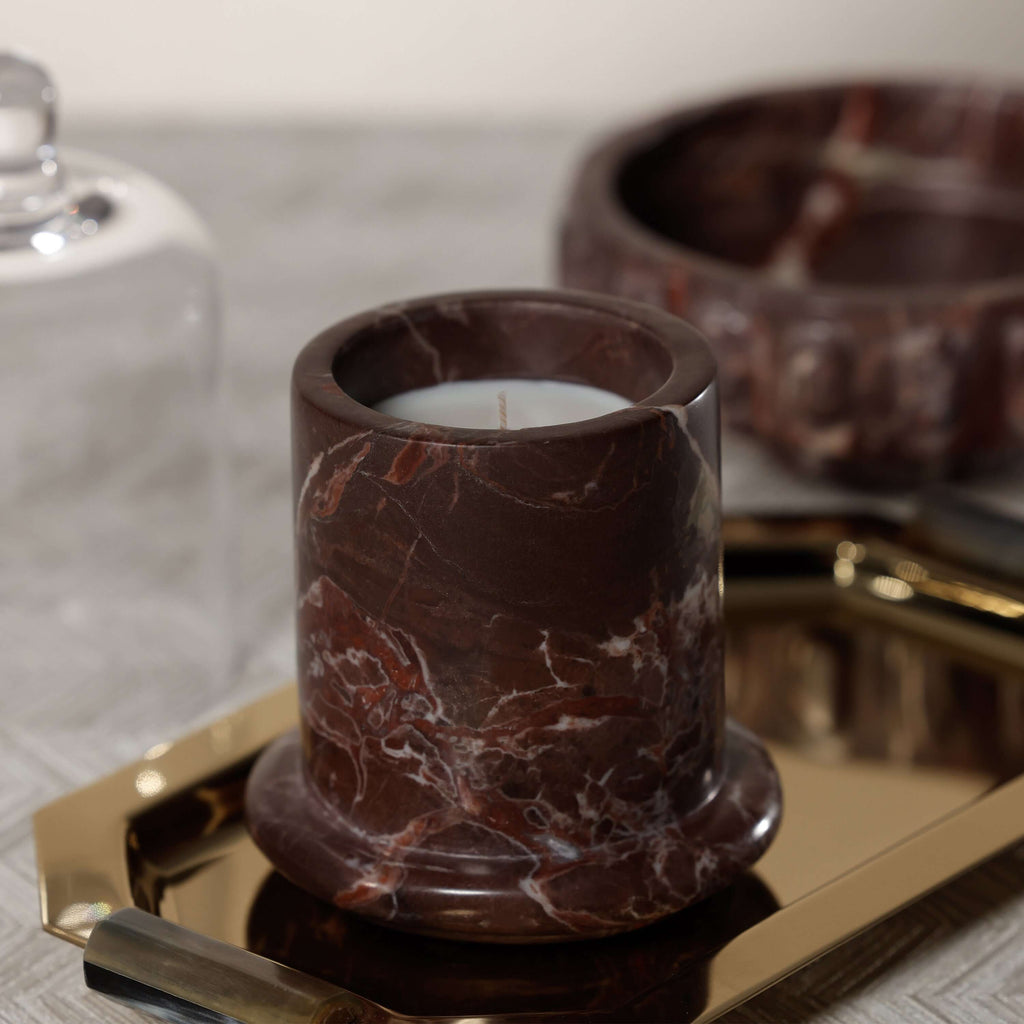 Marbella Scented Candle Jar with Cloche displayed on a gold tray, showcasing its unique marble design.