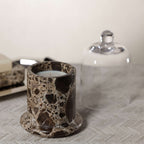 Marbella Scented Candle Jar with Cloche displayed on a textured surface, showcasing its unique marble design.