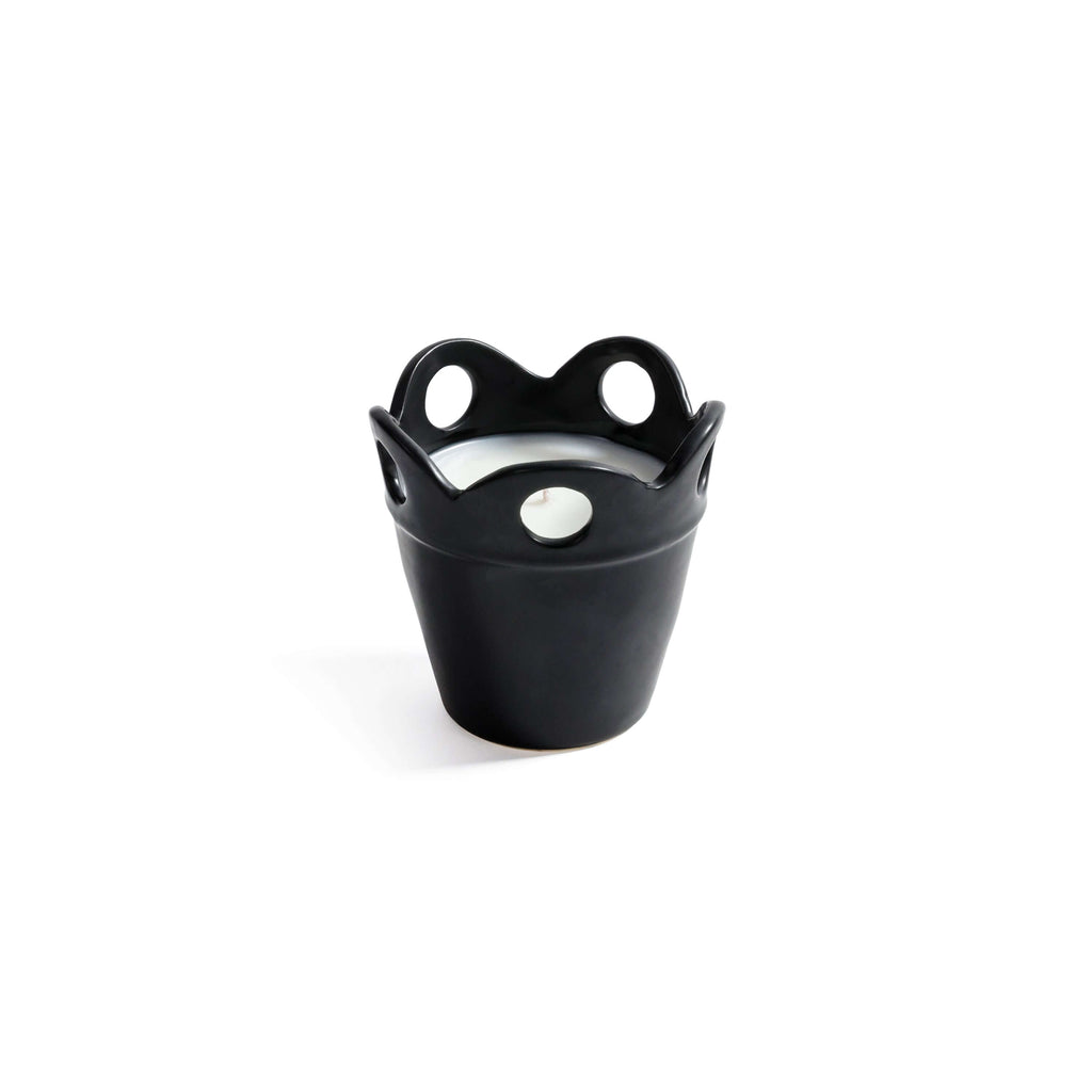 Citronella Pot Candle in small black ceramic with scalloped rim and cut-out details.