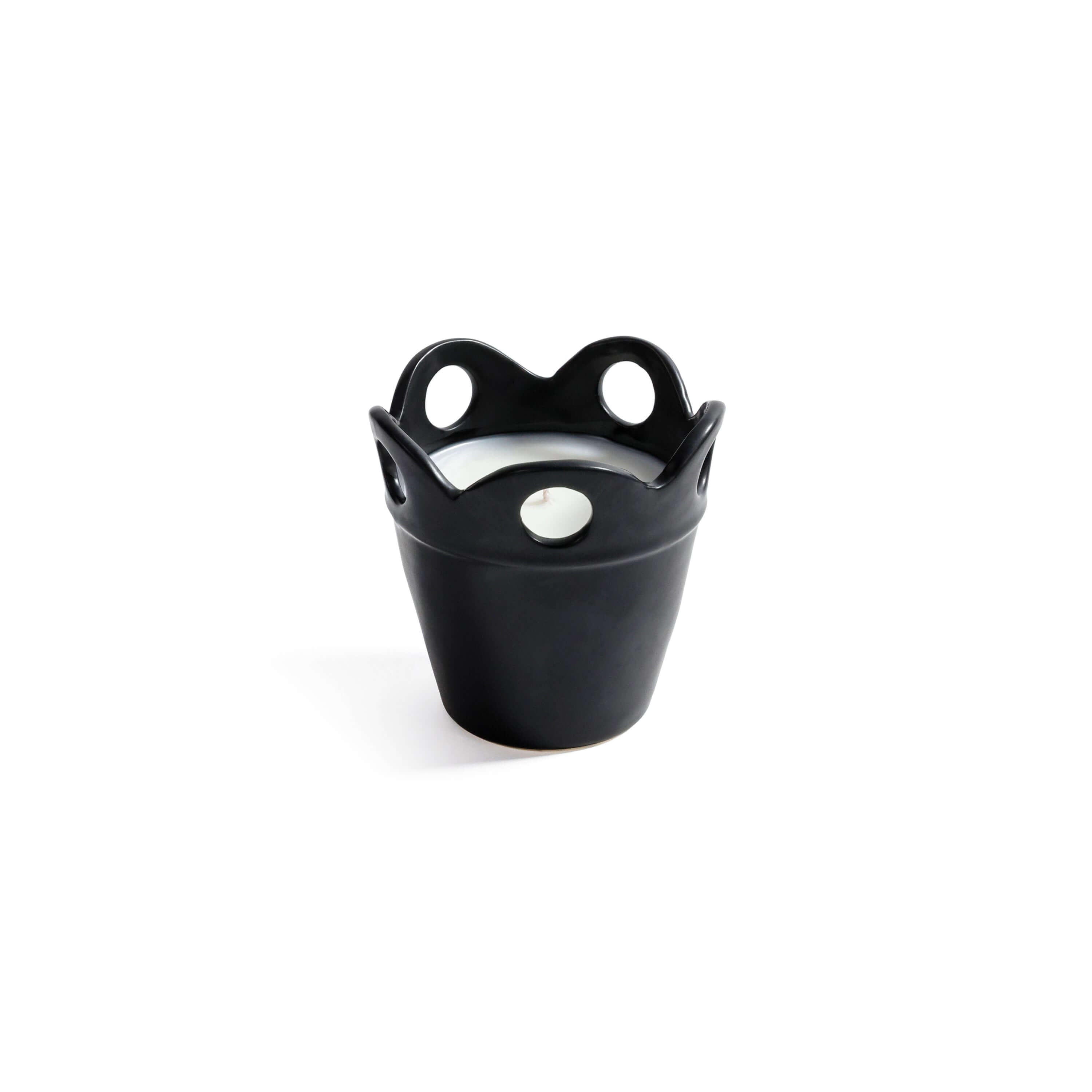 Citronella Pot Candle in small black ceramic with scalloped rim and cut-out details.