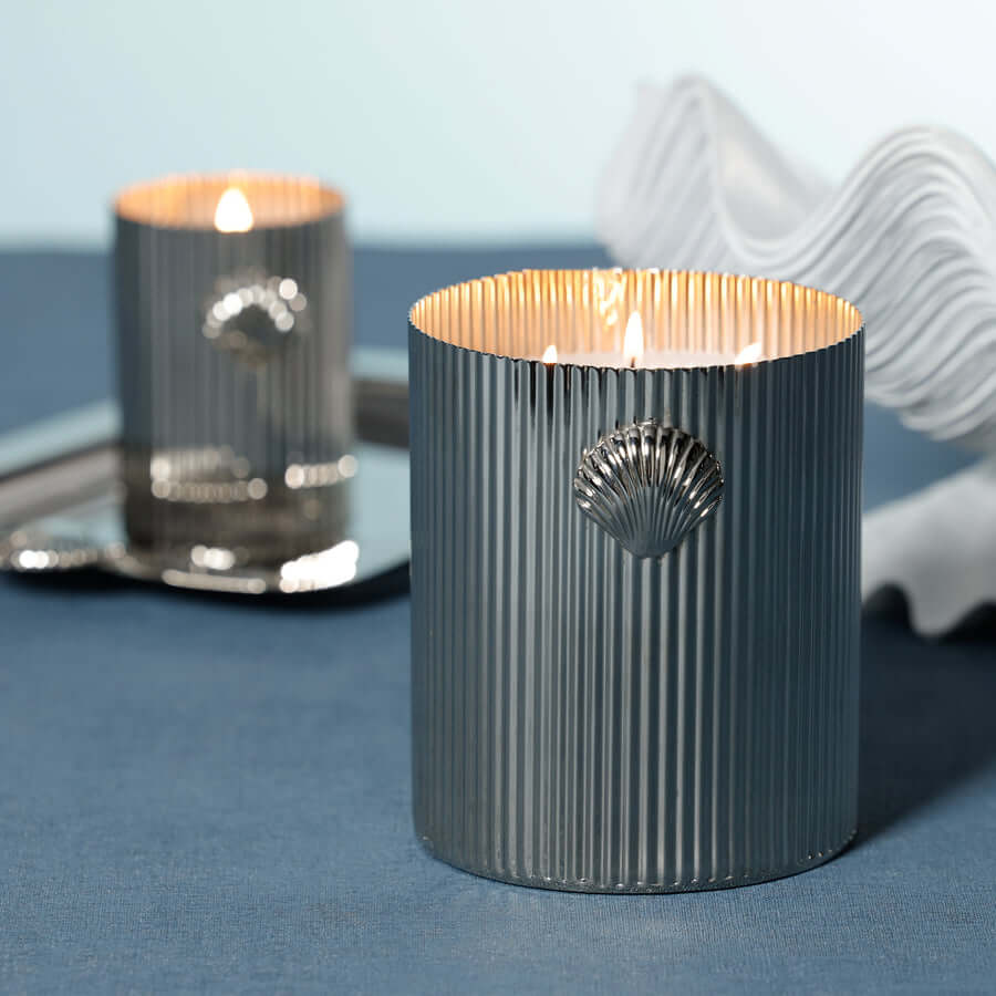 Cap Ferrat Fan Shell Design Candle in Gift Box displayed with fluted metal vessel and sea salt fragrance.