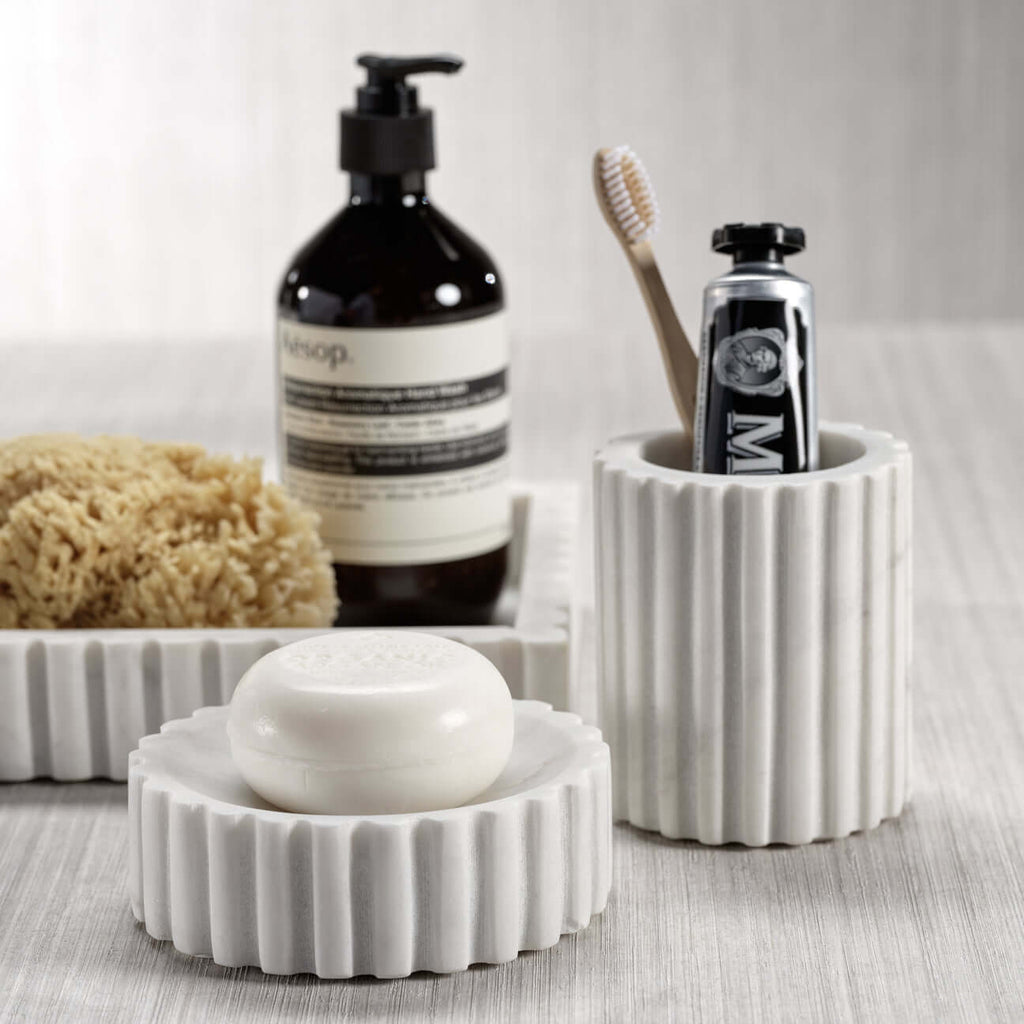 Camogli Bath Collection featuring marble soap dish and tumbler for an elegant bathroom design.