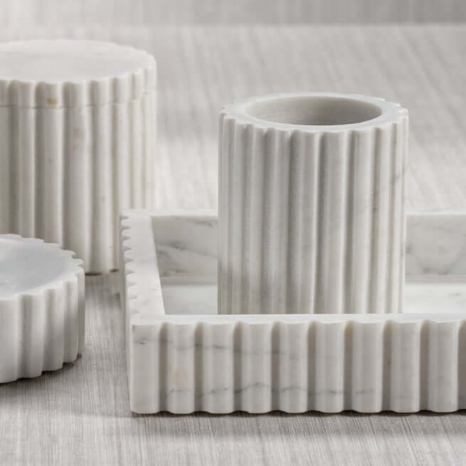 Camogli Bath Collection solid white marble pieces with sculpted vertical fluting for luxury bathroom decor.