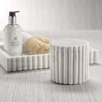 Elegant solid white marble canister from the Camogli Bath Collection with sculpted vertical fluting.
