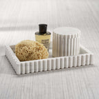 Camogli Bath Collection featuring a marble tray, sponge, and lotion bottle for a luxurious bathroom setup.