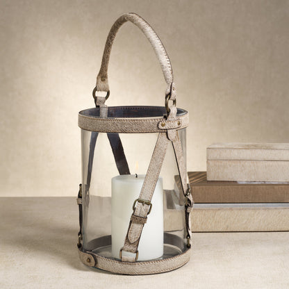 Decorative lantern with a candle inside on a neutral background