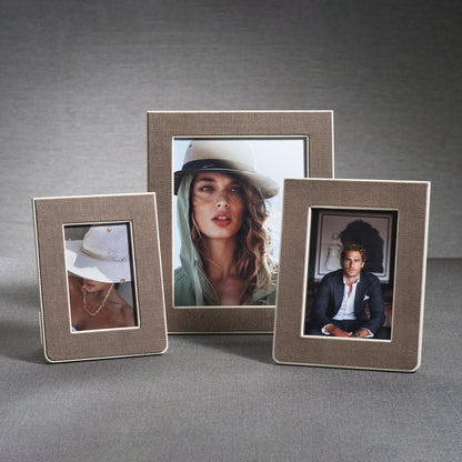Three photo frames with pictures of people on a gray background