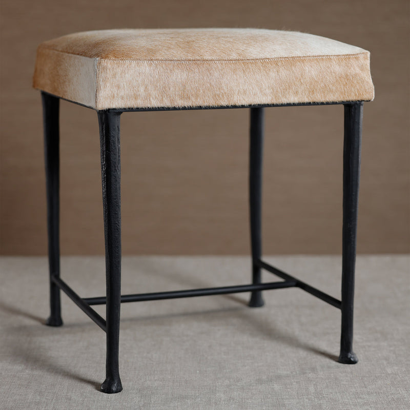 Bar stool with beige cushioned seat and black metal legs on a neutral background
