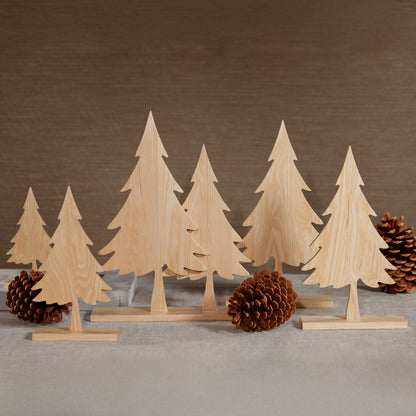 Set of wooden Christmas trees with pine cones on a neutral background