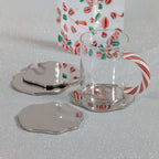 Clear glass mug with candy cane design on a white surface