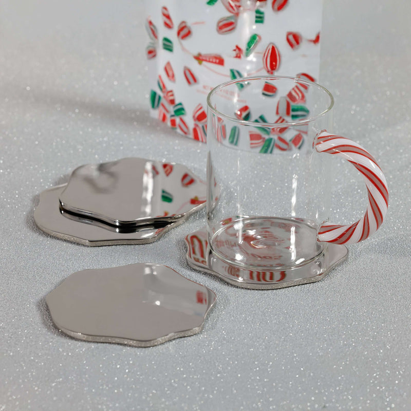 Clear glass mug with candy cane design on a white surface