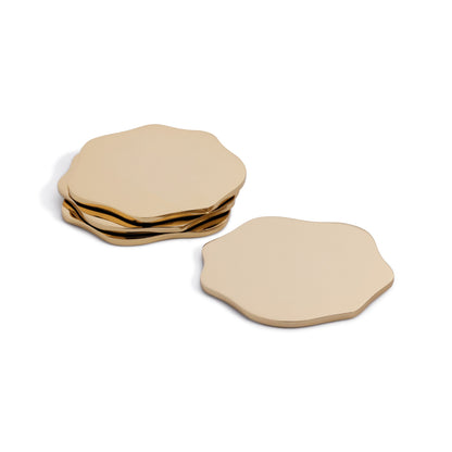 Set of gold hexagonal coasters on a white background