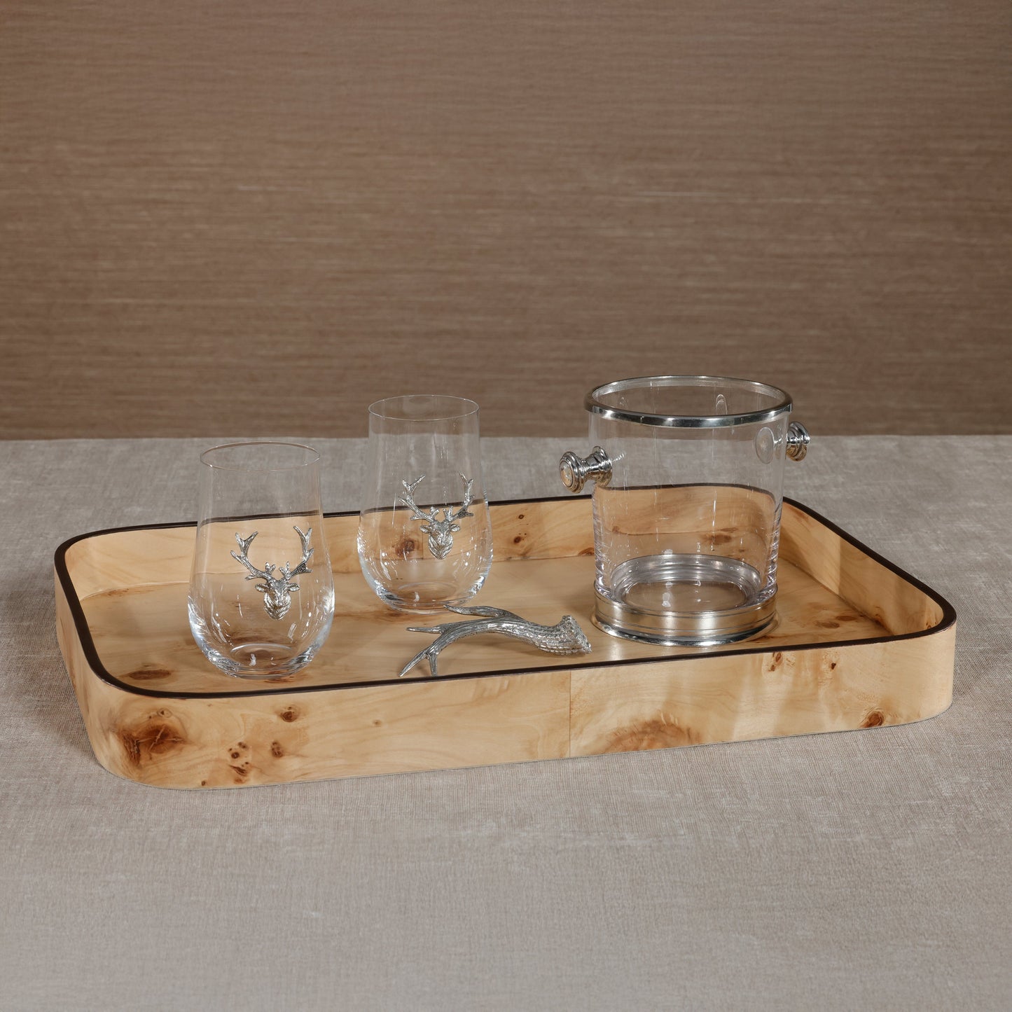 Wooden tray with glassware featuring deer designs on a neutral background