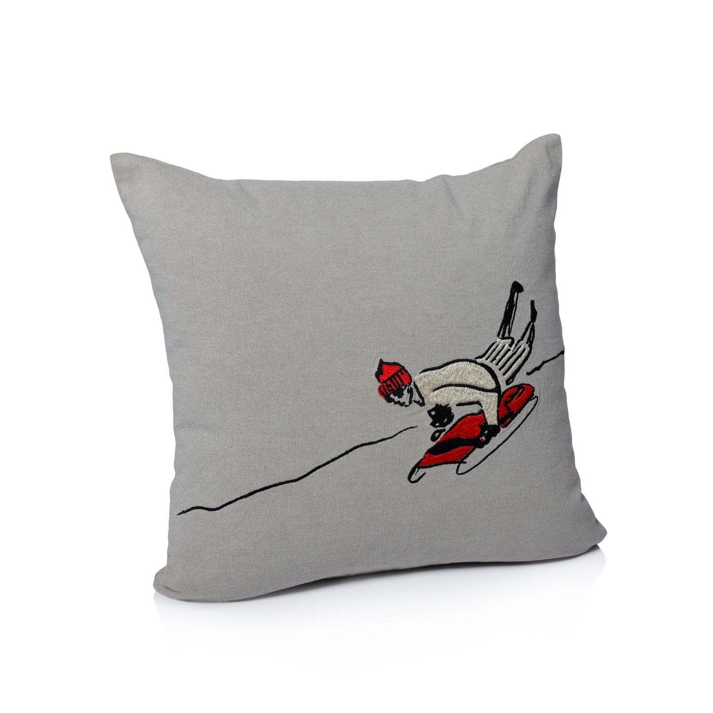 Gray pillow with a skier design on a white background