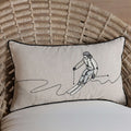 Decorative pillow with a skier design on a textured chair