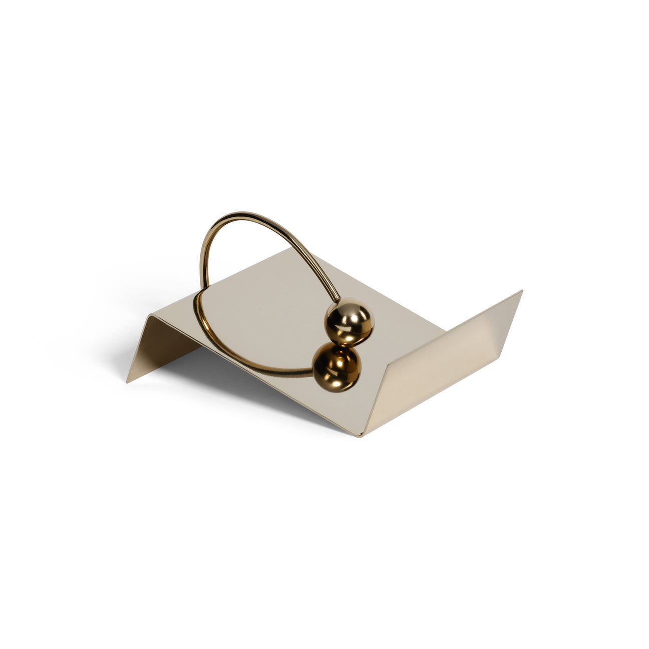 Gold napkin holder on a white stand with a white background