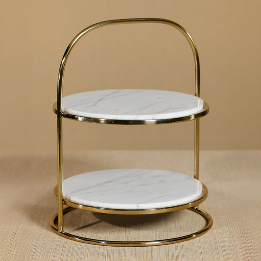 Two-tiered gold and marble stool on a beige background