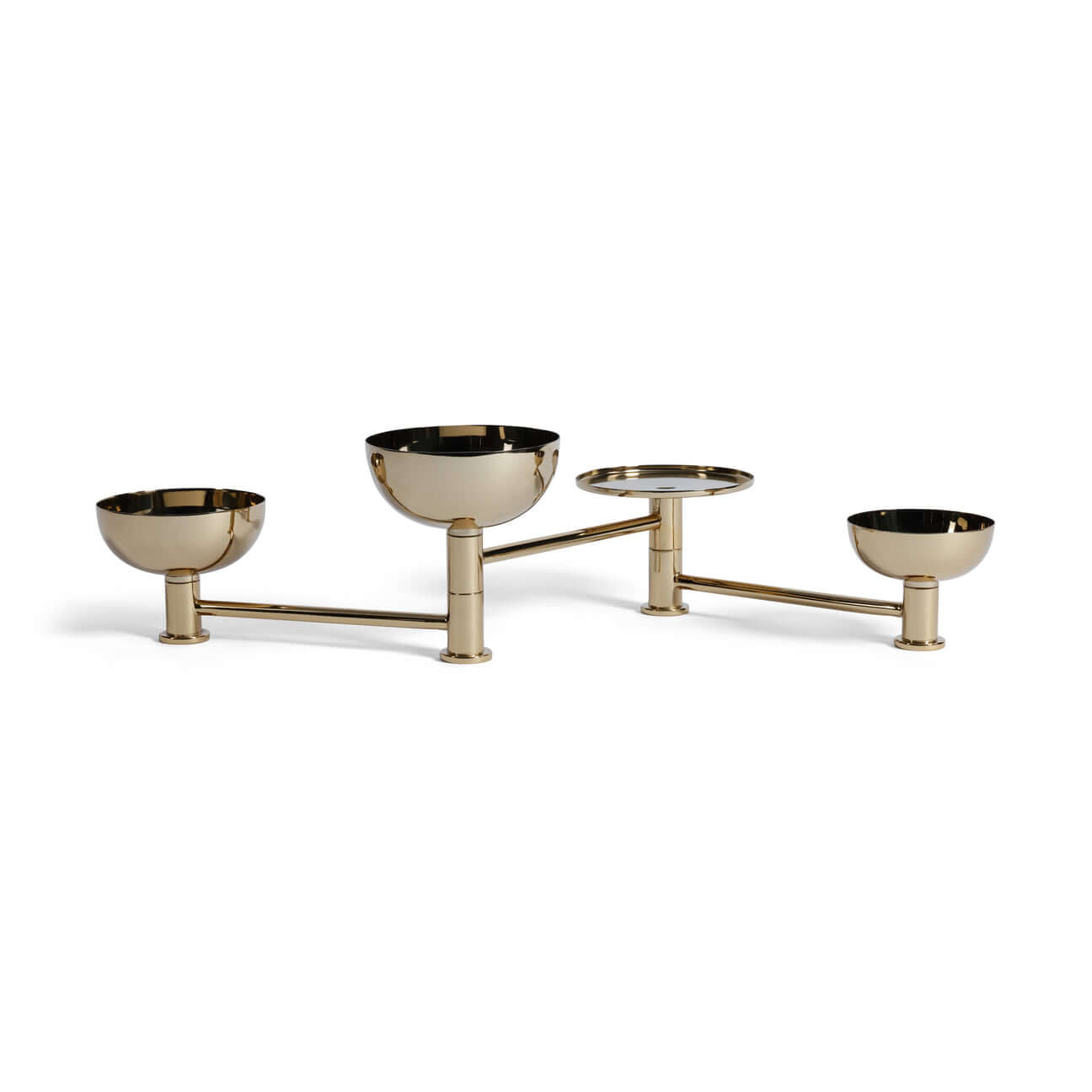 Brass condiment set with four bowls on a white background