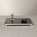 London Cheese and Charcuterie Marble Serving Tray with a glass and figs on a sleek black marble surface