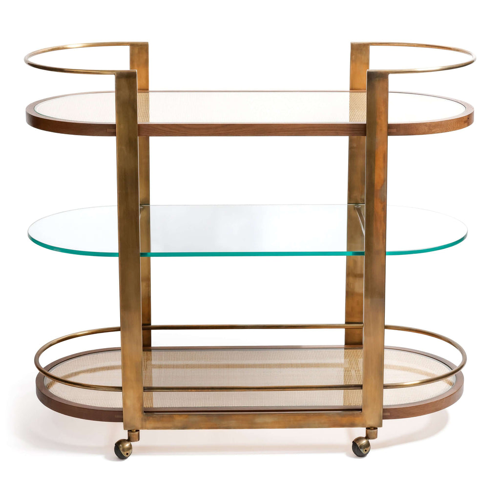 Sloane Oak Wood Oval Bar Cart featuring antique brass frame and glass shelves.
