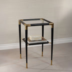 Peninsula Leather Side Table with black leather and brass details, featuring two tiers and a glass top.