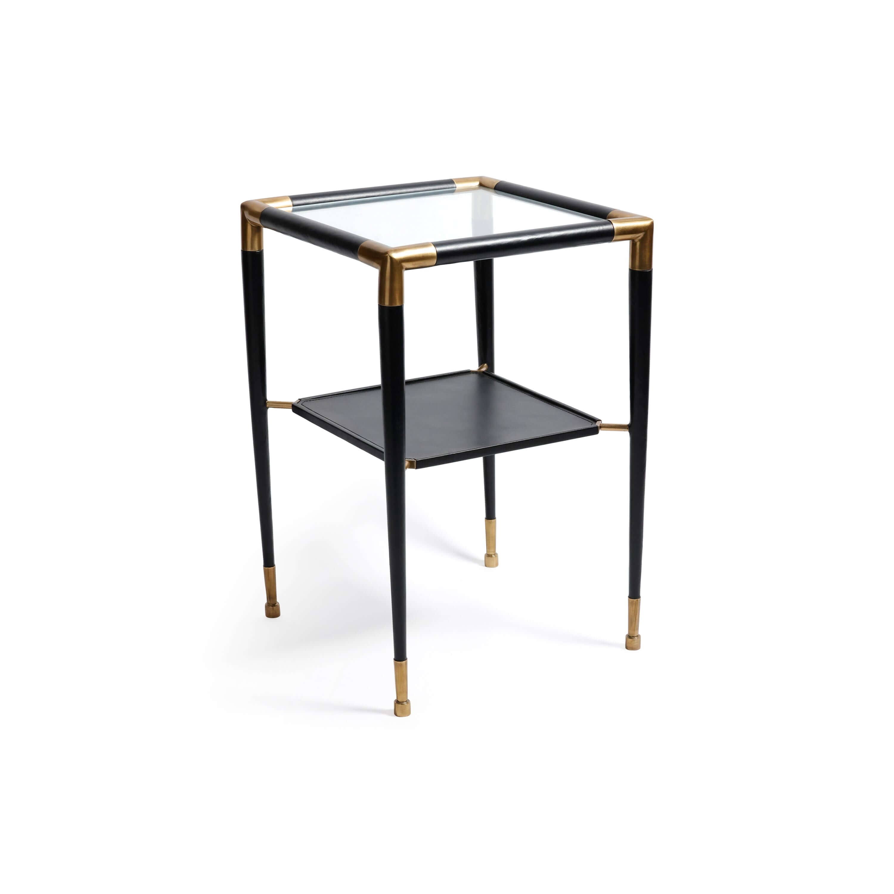 Peninsula Leather Side Table with brass joints and glass top, featuring a two-tier design and matte black finish.