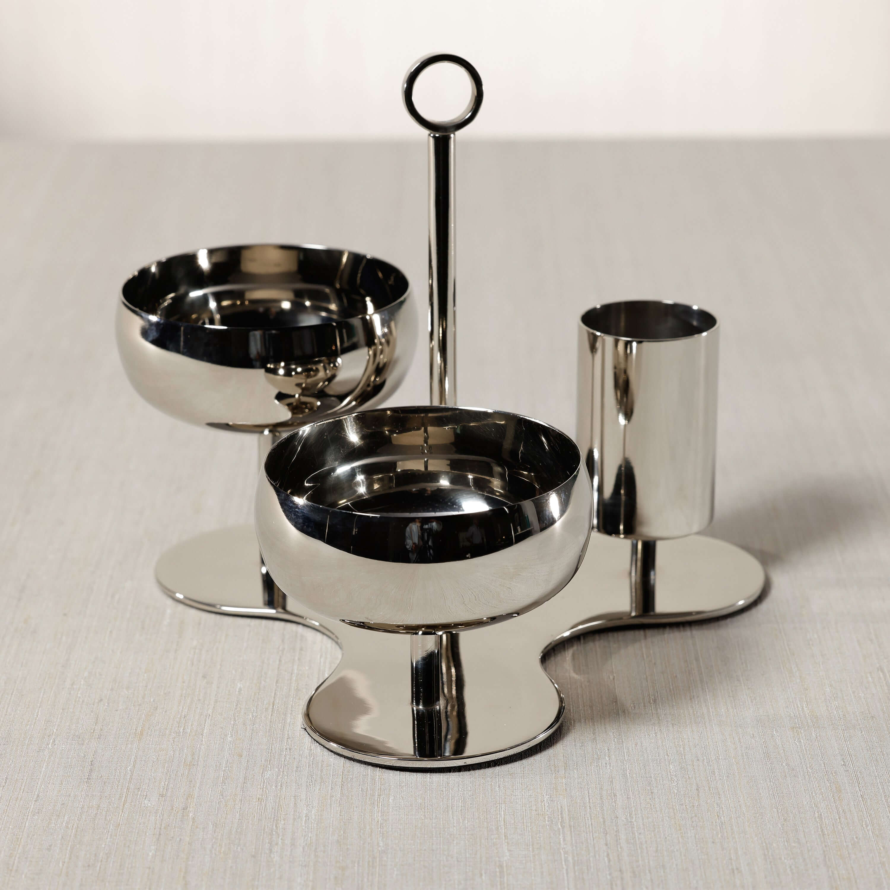 Locarno 3-Tier Condiment Set - PREORDER featuring polished bowls and a cylindrical holder on a sculptural base.