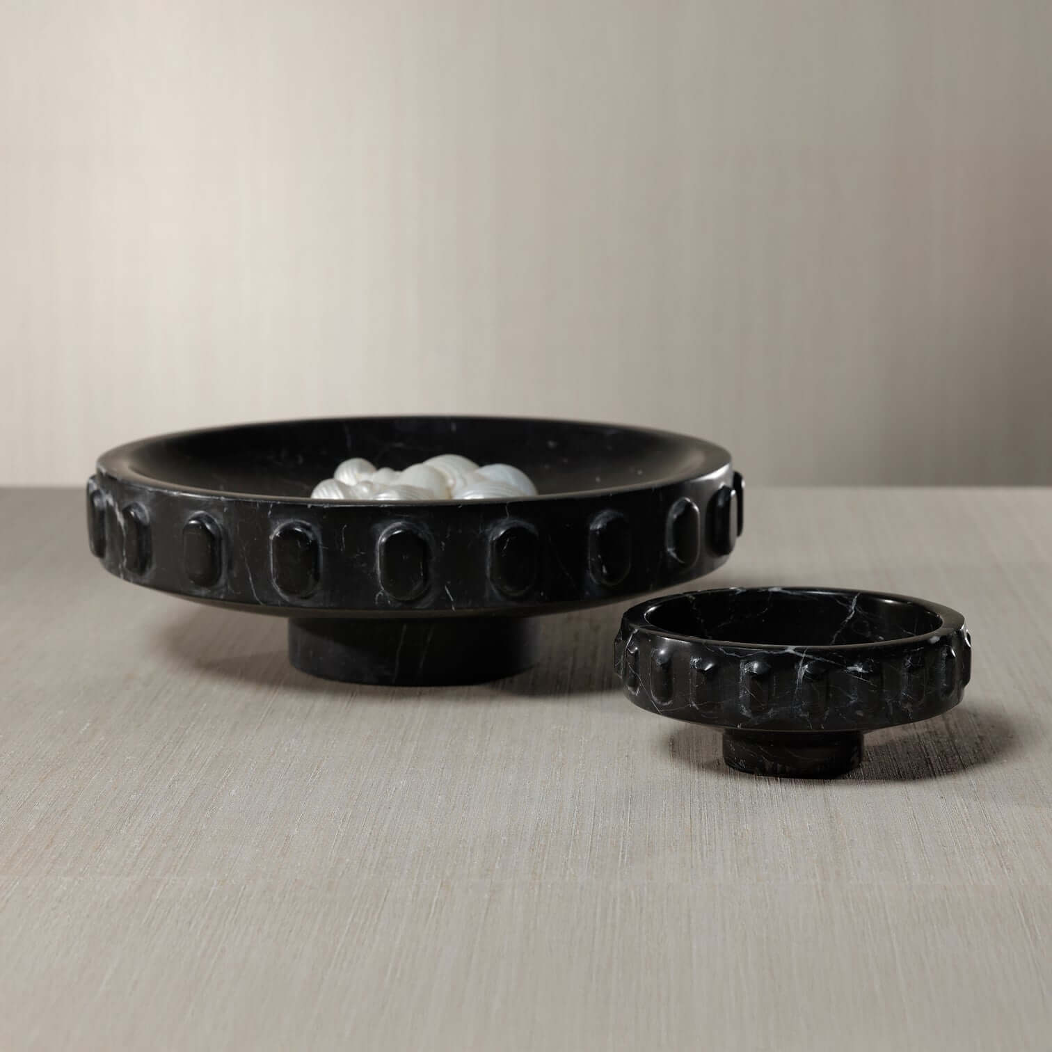 Black Marquina Marbella Bowl showcasing elegant silver veining and carved medallion details.
