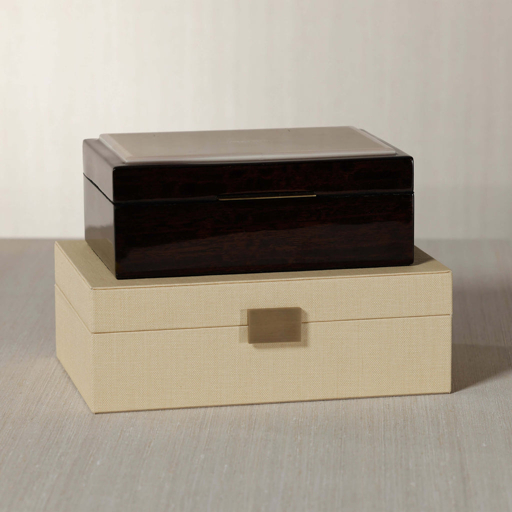 The Langham Box, featuring dark espresso wood veneer and a luxurious design, elegantly displayed on a neutral surface.