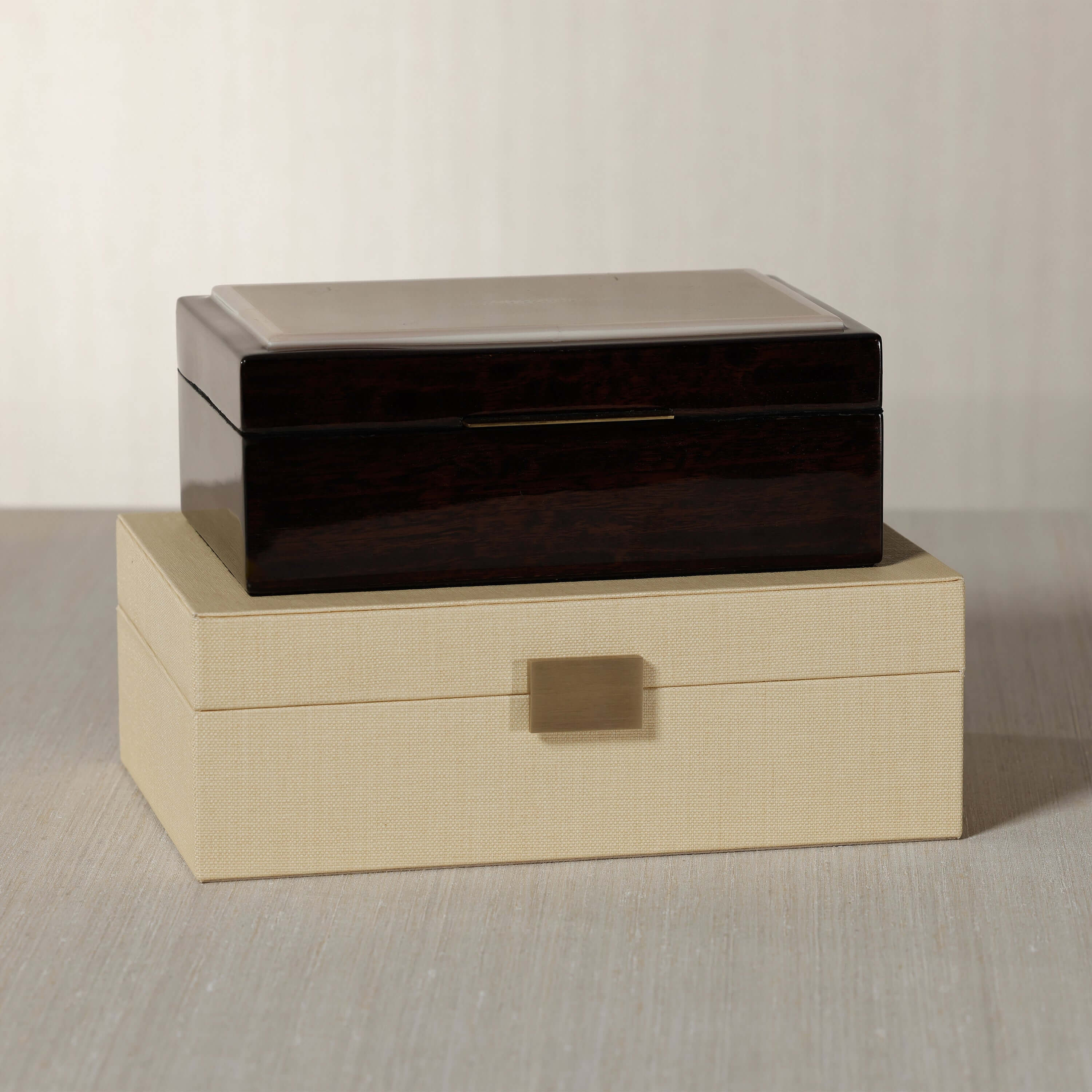The Langham Box, featuring dark espresso wood veneer and a luxurious design, elegantly displayed on a neutral surface.