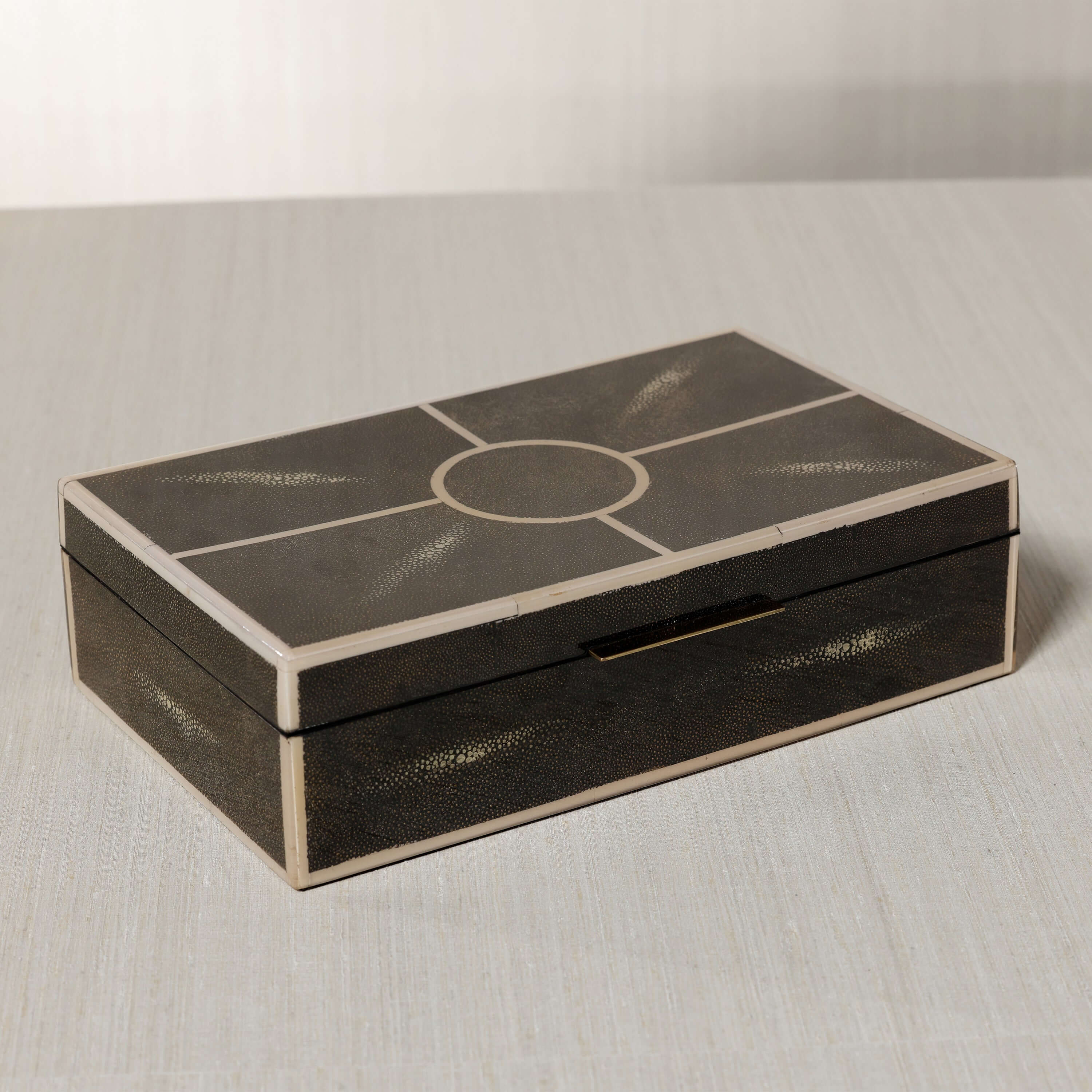 The Corinthia Box showcasing elegant deep charcoal shagreen with cream resin border and dense textured surface.