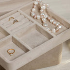 Interior view of Linea Suede Jewelry Box showcasing compartments and jewelry pieces.
