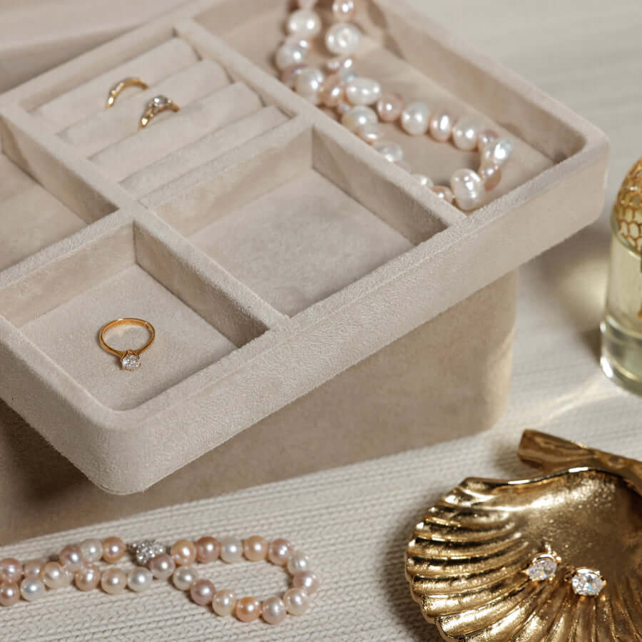 Linea Suede Jewelry Box with gold rings, pearls, and elegant decor, showcasing premium jewelry storage.