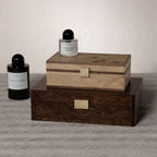 Linea Heritage Burl Veneer Jewelry Box displayed with candles and perfumes on a textured surface.