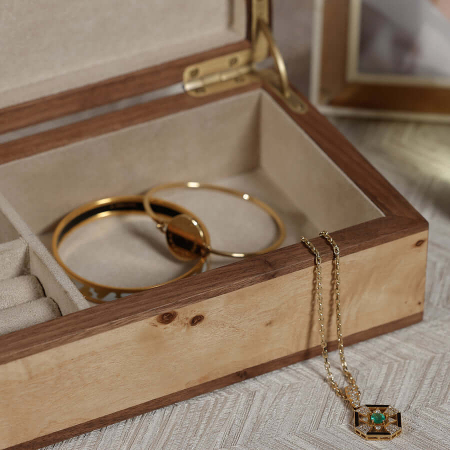 Inside view of the Linea Heritage Burl Veneer Jewelry Box showcasing gold jewelry pieces.