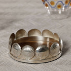 Sur Mer Shell Design Bottle Coaster with sculpted shell motifs in polished metal finish, perfect for elegant dining.