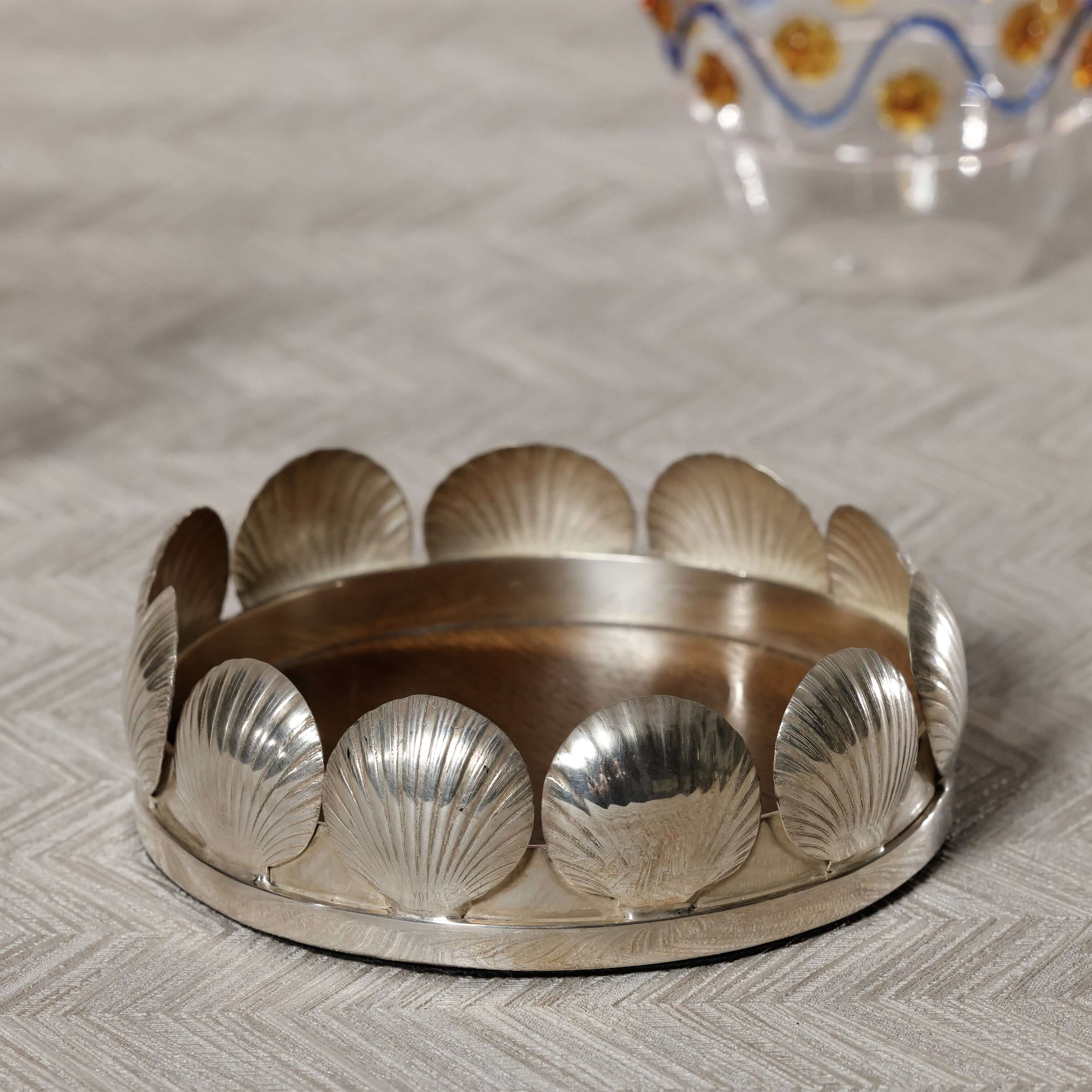 Sur Mer Shell Design Bottle Coaster with sculpted shell motifs in polished metal finish, perfect for elegant dining.