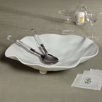 Mougins Salad Server Set with Acrylic Handle displayed on a stylish white bowl with glassware.