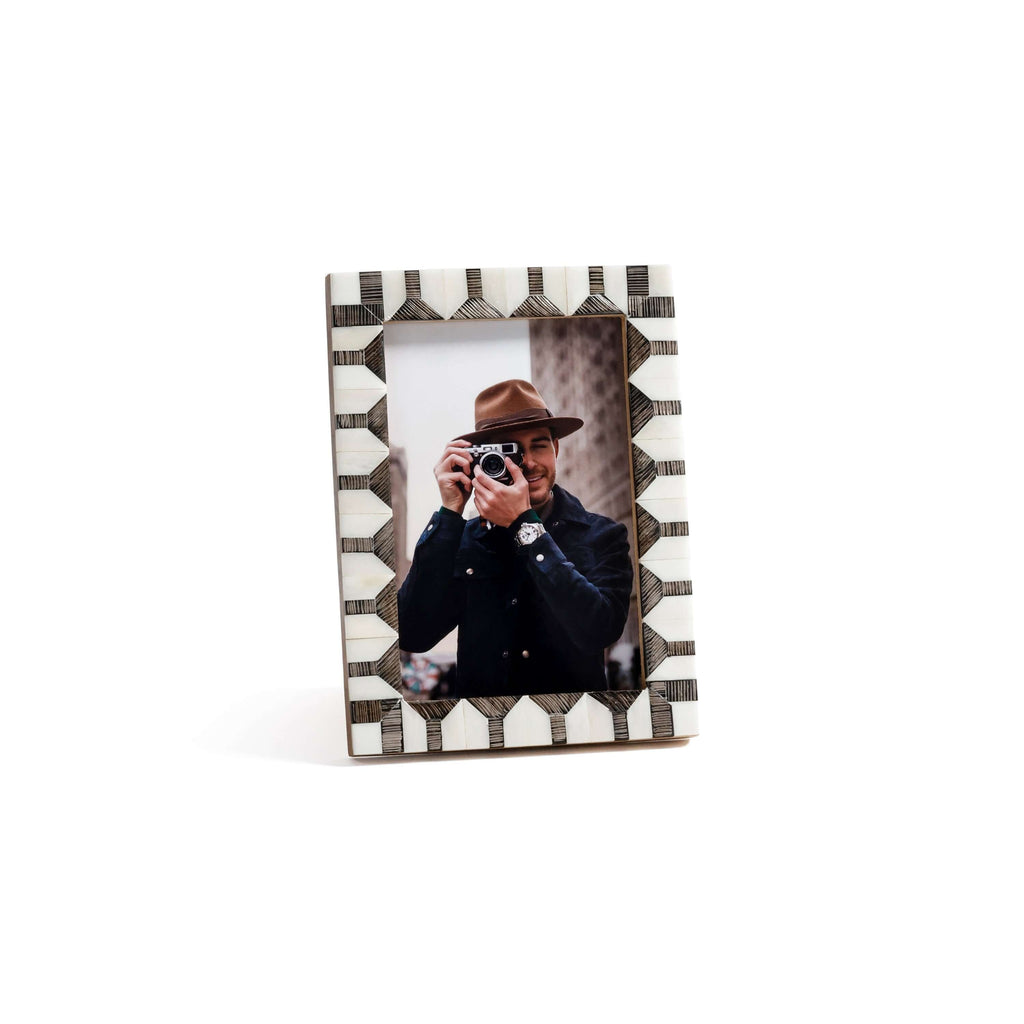 Lagos White Bone & Chiseled Horn Inlaid Photo Frame displaying a photo of a man with a camera, featuring geometric chevron design.