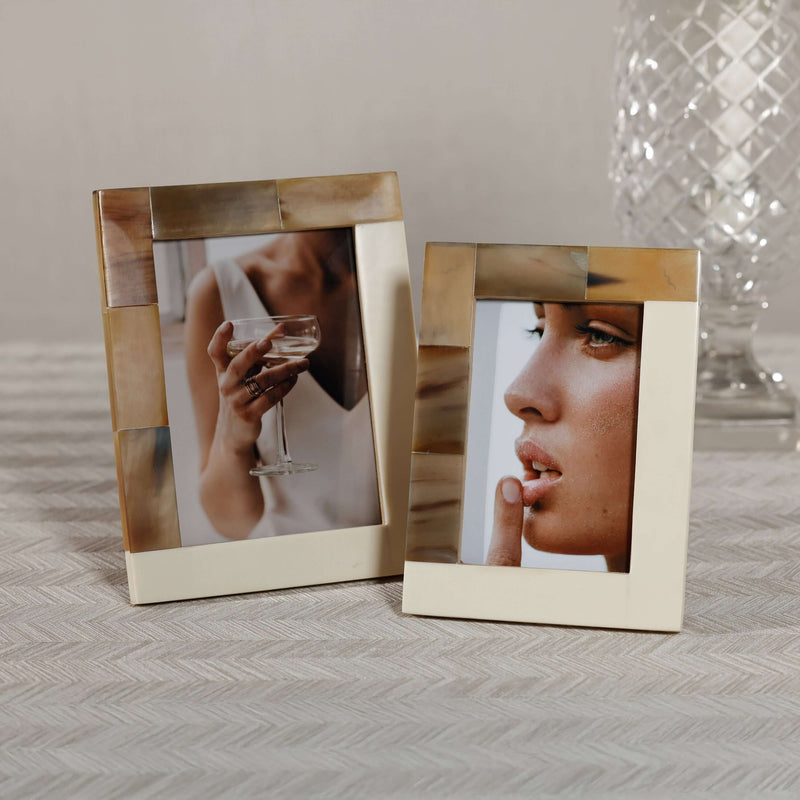 White Horn and Ivory Resin Photo Frame displayed with elegant photos, showcasing unique horn accents.