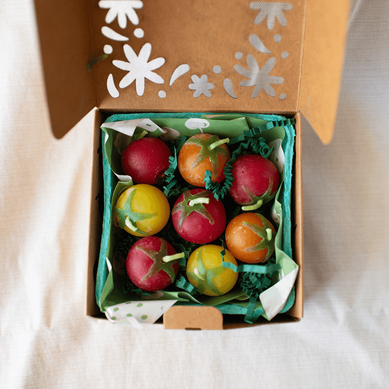 Cherry Tomato Beeswax Birthday Candles 8-count in a decorative box with green filler and floral design.