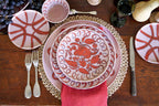 Amalfi Dessert Plate Pink - 9.1" Diameter styled on a rustic table with silverware and decorative elements.