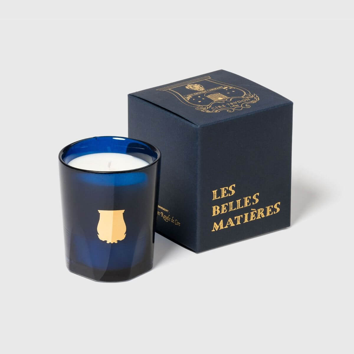 Madurai Petite Candle in elegant blue glass jar with luxurious packaging.