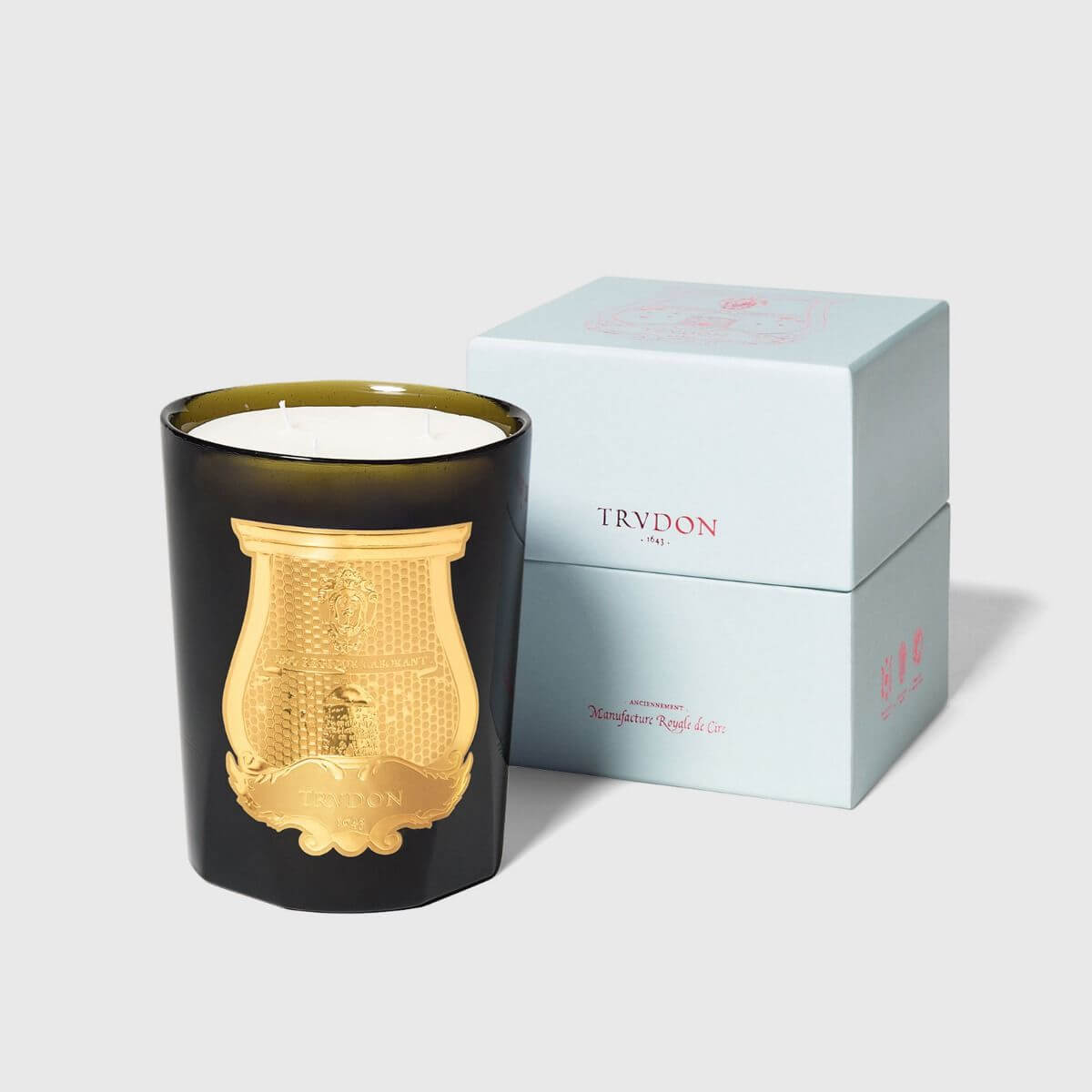 Abd El Kader Intermezzo Candle in a black vessel with gold emblem, packaged elegantly in a light blue box.